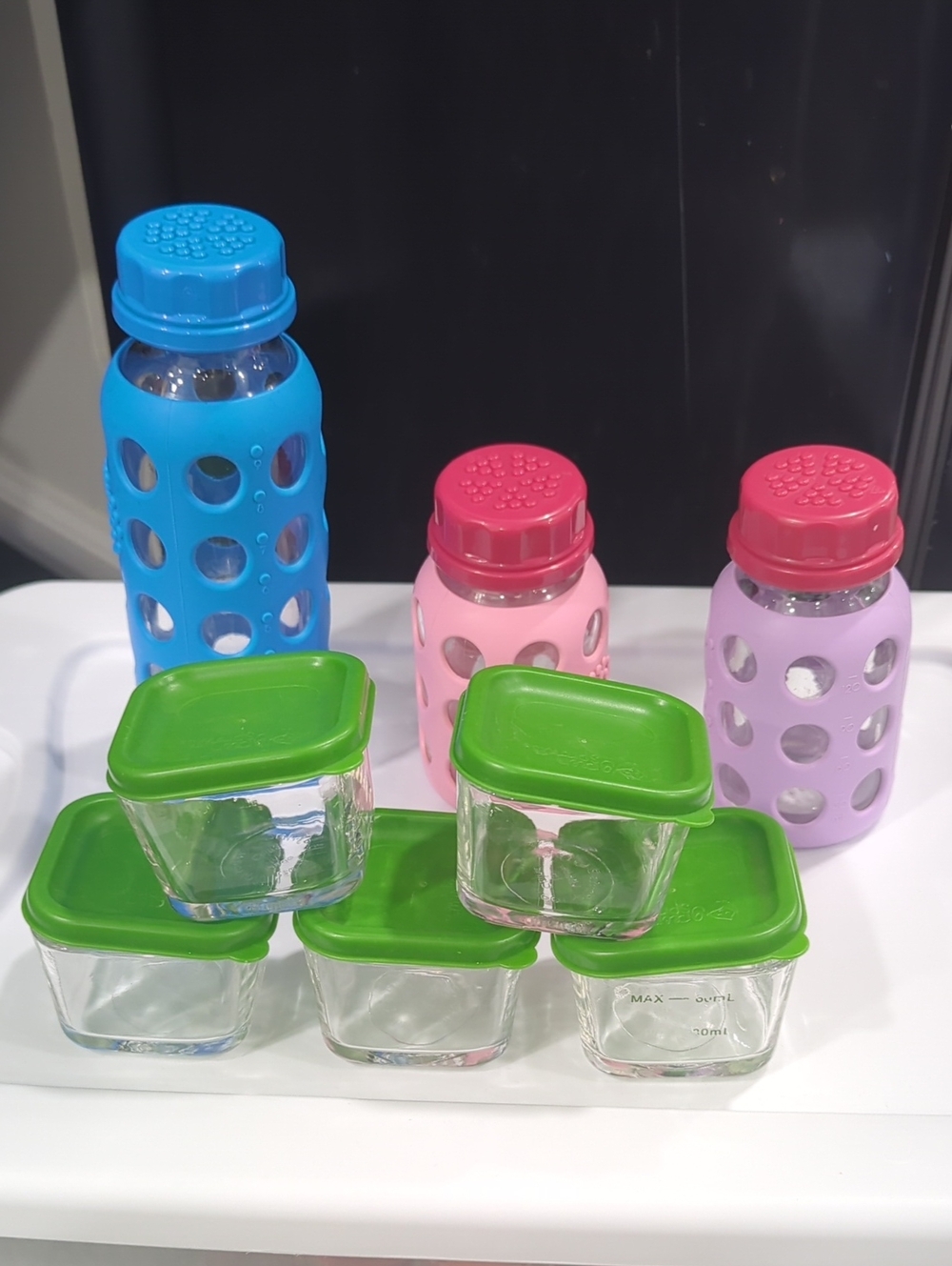 Glass Food Storage Set with Green Lids and Assorted Silicone Bottles